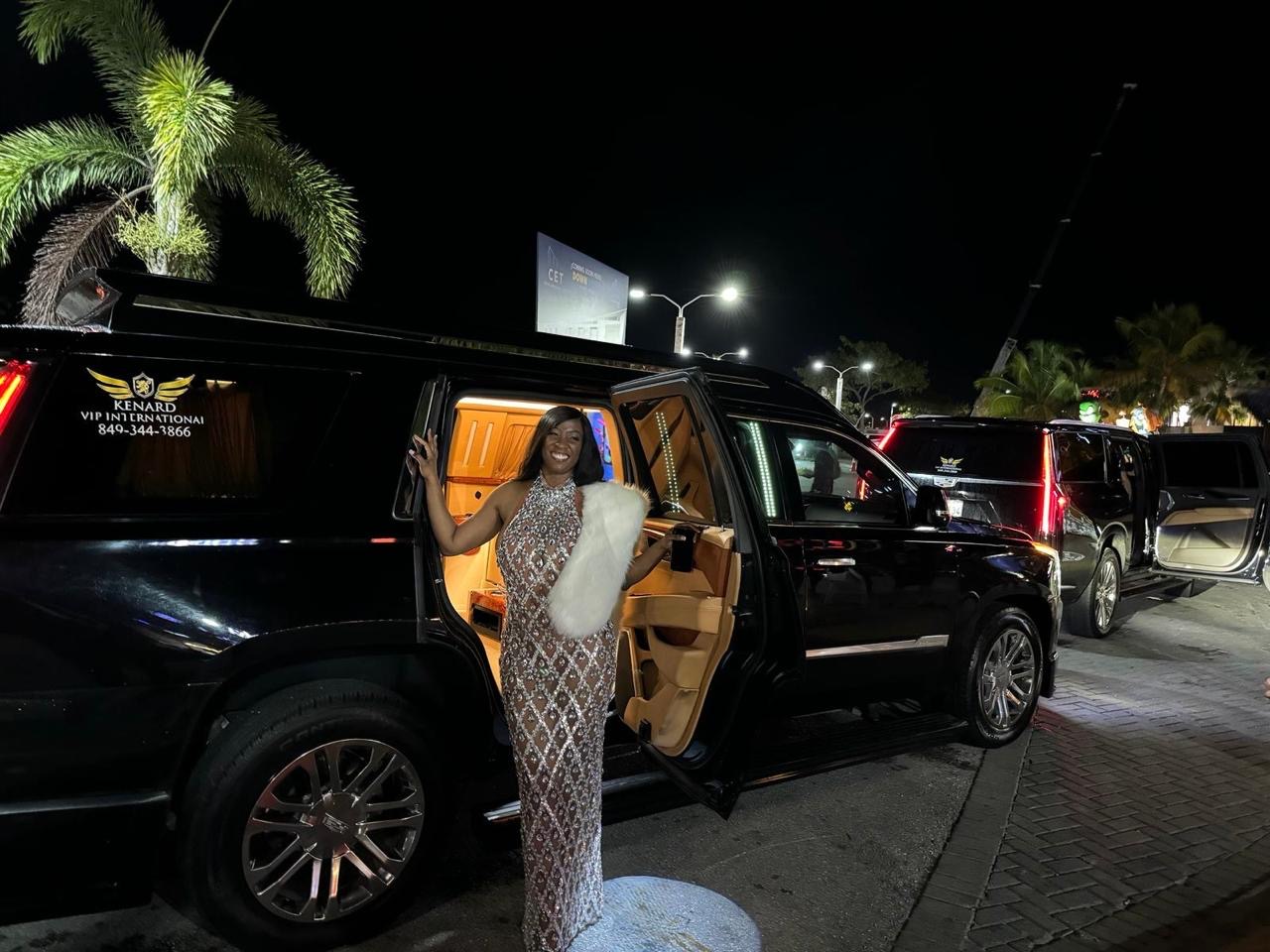 VIP chauffeur greeting guests for luxury transportation at night